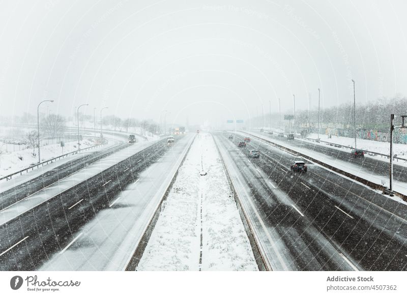 Autofahrt auf einer asphaltierten Straße bei Schneefall PKW Laufwerk Winter Verkehr Dunst Nebel trist Asphalt Bewegung kalt Fahrbahn Frost Winterzeit Fahrzeug
