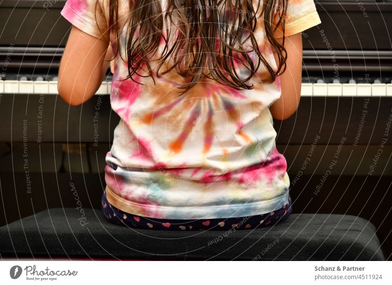 Mädchen spielt Klavier Kind lange Haare Instrument Tasten Bildung Batik Hocker Klavierhocker Klavierspielen