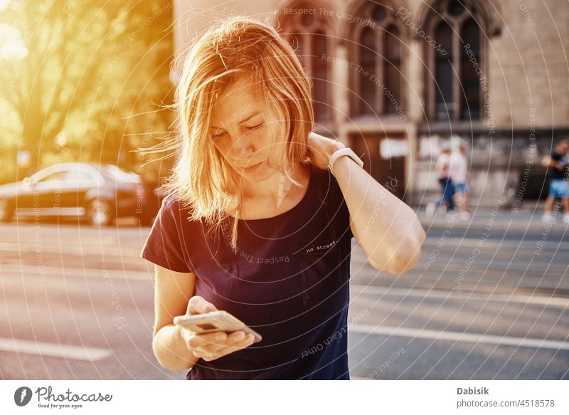Frau benutzt Smartphone auf einer Straße in der Stadt Mobile laufen Lifestyle Kommunizieren online Porträt Telefon benutzend Fröhlichkeit tragbar Information