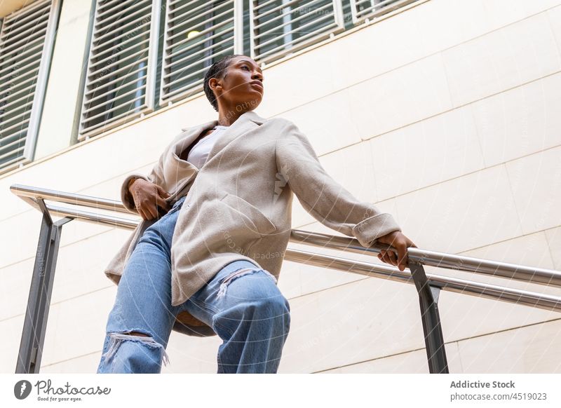Stilvolle schwarze Frau in der Nähe des Geländers Straße trendy Outfit Großstadt Gebäude Kleidung Reling urban Kleidungsstück Afroamerikaner Dame modern