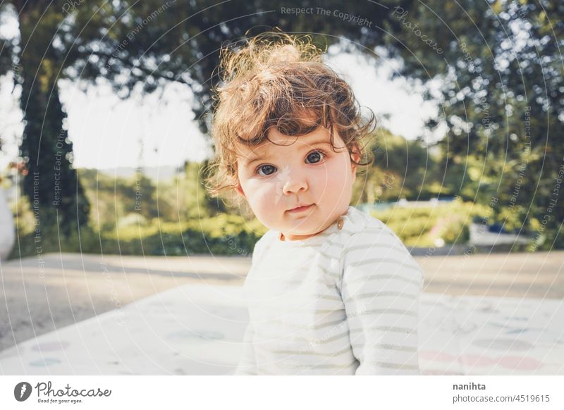Natürliches Porträt eines einjährigen süßen Babys niedlich lockig im Freien wirklich bezaubernd sonnig Tag Park Natur natürlich Kleinkind Kind Säuglingsalter