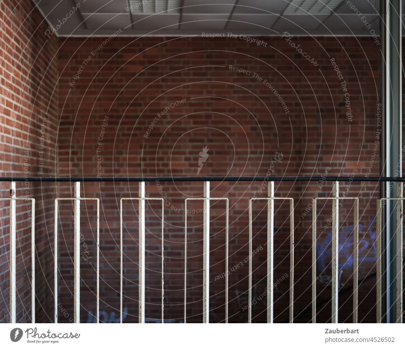 Geländer vor Ziegelwand in Treppenhaus weiß schwarz Gebäude DDR Architektur Treppengeländer Wand Mauer schlicht geradlinig ordentlich Ordnung