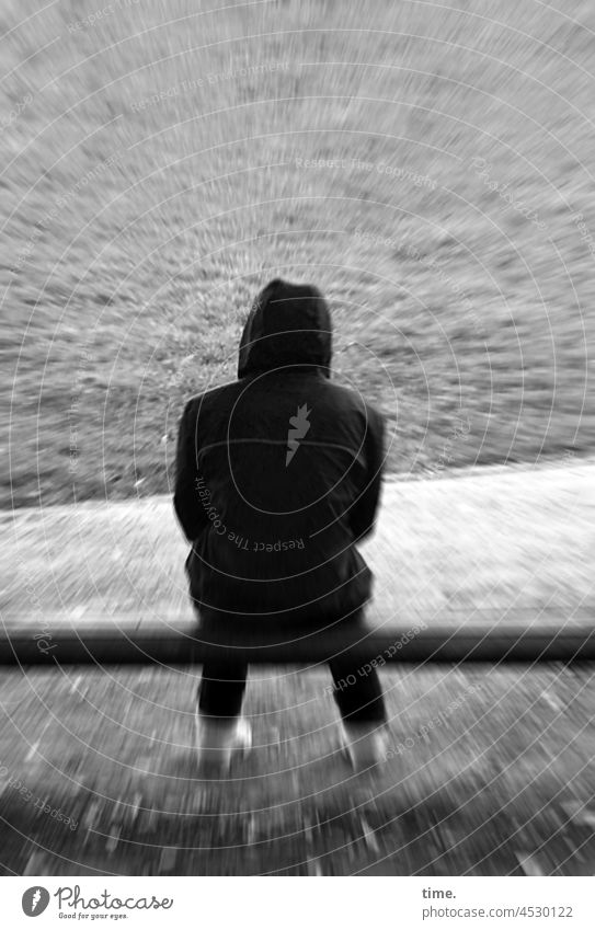 under pressure • Rückansicht eines Mannes mit Hoodie auf einer Parkbank mann jacke kapuze sitzen rückansicht wiese effekt anorak hoodie