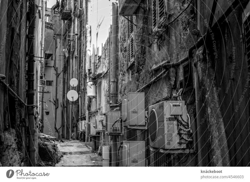 klimatisiert dystopisch dunkel Klimaanlage Schatten Seitenstraße Menschenleer Stadt Wand Gasse Schwarzweißfoto Südeuropa Korsika Altstadt Angstraum