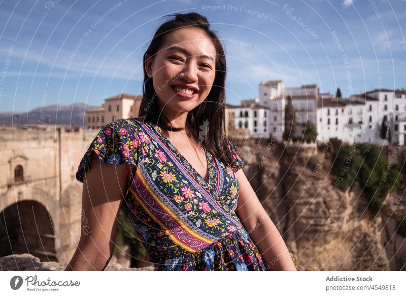 Glückliche Asiatin sitzt in der Nähe der historischen Brücke in Ronda Frau reisen antik alt Klippe Berge u. Gebirge Natur Tourist gealtert Architektur