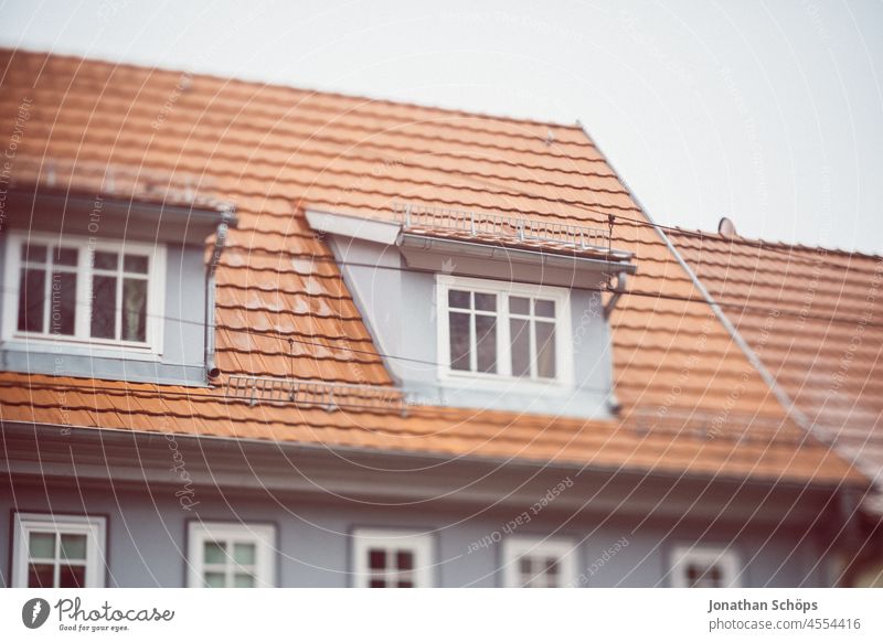 Dachfenster an Dach mit roten Dachziegeln Haus Wohnen Miete Mietpreise Winter kalt Mehrfamilienhaus Altbau wohnen Fenster Architektur mietshaus mehrfamilienhaus