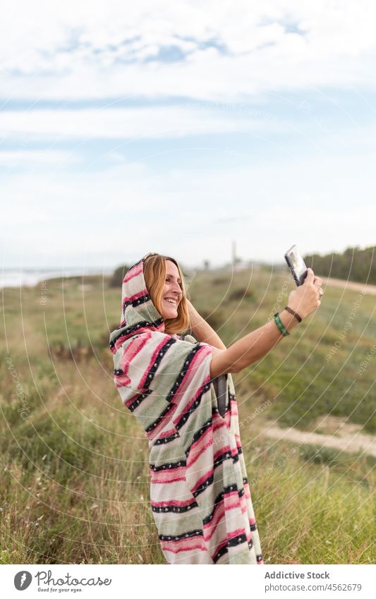 Fröhliche Frau nimmt Selfie in der Natur Smartphone Selbstportrait einfangen Fotografie Zeitvertreib Freizeit Erholung Gras Moment Dame Lächeln Mobile Telefon