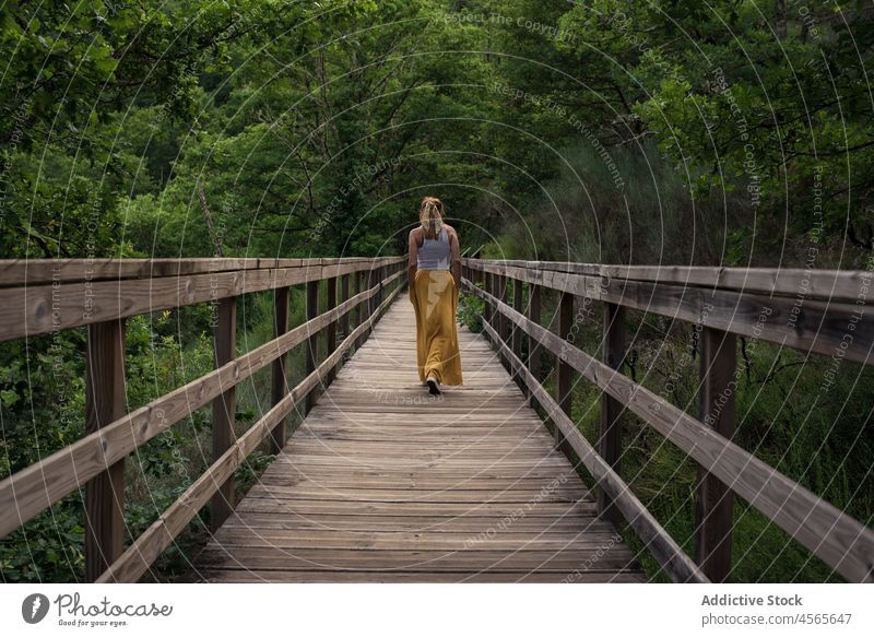 Junge Frau steht auf einem Holzsteg in einem grünen Bergtal Steg Fluss Mao Galicia Sakrament Spanien Reisender Brücke Natur Tourismus Tourist reisen erkunden