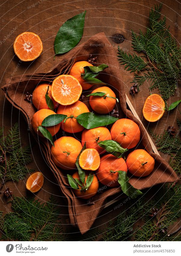 Reife Mandarine bei grünen Zweigen Frucht Zitrusfrüchte Stapel Vitamin gesunde Ernährung organisch Lebensmittel natürlich Haufen Container frisch Tisch reif
