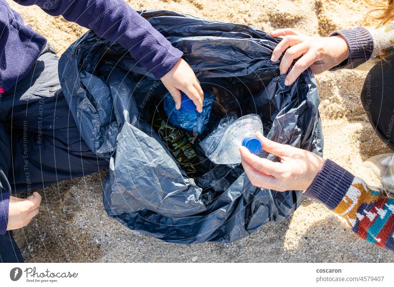 Mutter und Sohn sammeln Plastik und Müll am Strand auf Flasche Pflege Kaukasier Kind Sauberkeit Säuberung Küste abholen sammelnd dreckig Ökologie Umwelt