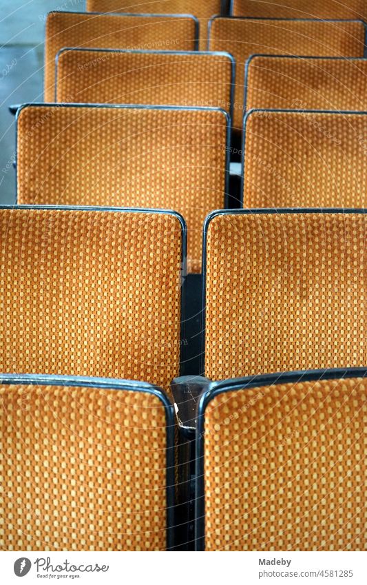 Alte Kinostühle und Sitzreihen mit Stoffbezug im Stil und den Farben der Siebzigerjahre in einer alten Fabrikhalle mit Antiquitäten im Stadtviertel Margaretenhütte in Gießen an der Lahn in Hessen