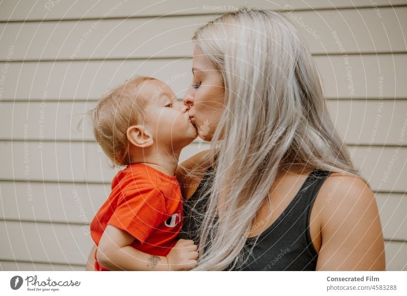 Kleiner goldblonder Junge küsst seine Mutter auf die Lippen Kind Kinder Kindheit Küssen Kuss Mama Mutterschaft Eltern Glück Liebe Zusammensein Frau reisen