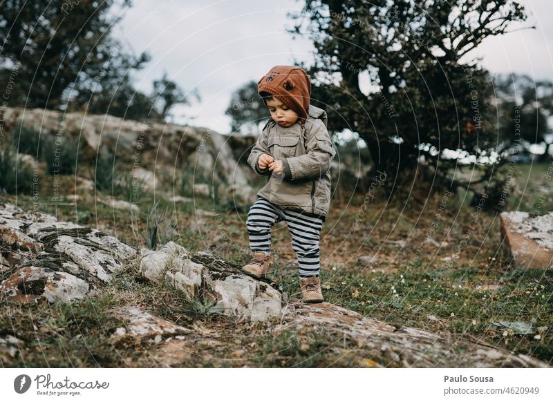 Kind mit gelber Kapuzenjacke Kindheit 1-3 Jahre Junge Kaukasier Neugier erkunden im Freien Umwelt Natur Freizeit & Hobby authentisch Glück Fröhlichkeit Tag