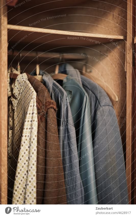 Alte Arbeitskleidung in einem Spind aus Holz Kleidung Holzspind Schrank Hemd Jacke Bügel Kleiderstange vergessen verlassen Kleiderbügel Bekleidung hängen