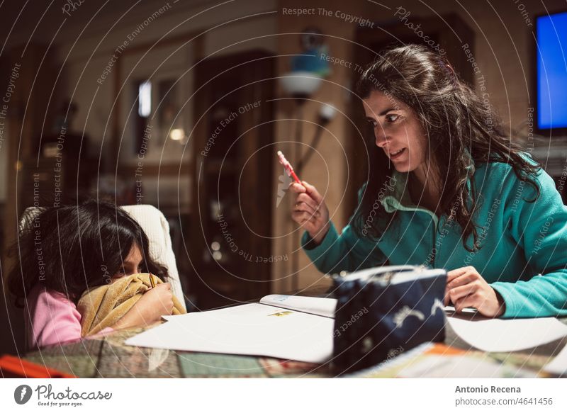 Eine Mutter schimpft mit ihrer Tochter, während sie zu Hause Hausaufgaben macht Kinder Hausarbeiten heimisch realistisch Trainingsanzug heimwärts Bücher Schüler