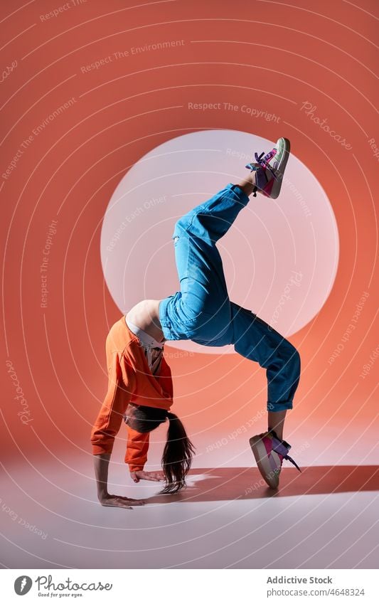 Flexible Frau in Radstellung mit angehobenem Bein Tänzer ausführen Tanzen üben Choreographie Dehnung Kunst beweglich Anmut Stil aktiv Aktion Körperhaltung