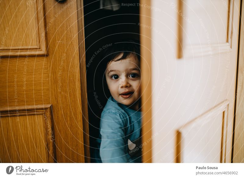 Kind versteckt sich auf dem Kleiderschrank Kindheit 1-3 Jahre Kaukasier authentisch Lifestyle Farbfoto Leben Kindheitserinnerung Mensch Freude Tag
