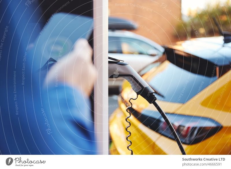Elektroauto mit Smartphone-App an der Straße angeschlossen EV verstopft elektrisch PKW Aufladen außerhalb heimwärts Haus Schnellladung Punkt Gebühr Fahrzeug