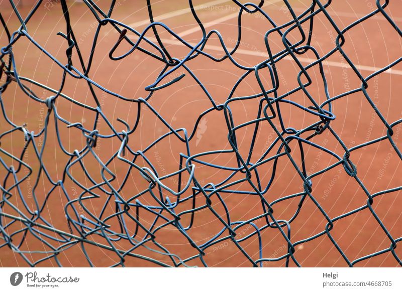 Flickwerk - Maschendrahtzaun mit einem laienhaft geflickten Loch am Rande eines Tennisplatzes Zaun Sicherheit Abgrenzung Draht Metall Drahtzaun Netzwerk Schutz