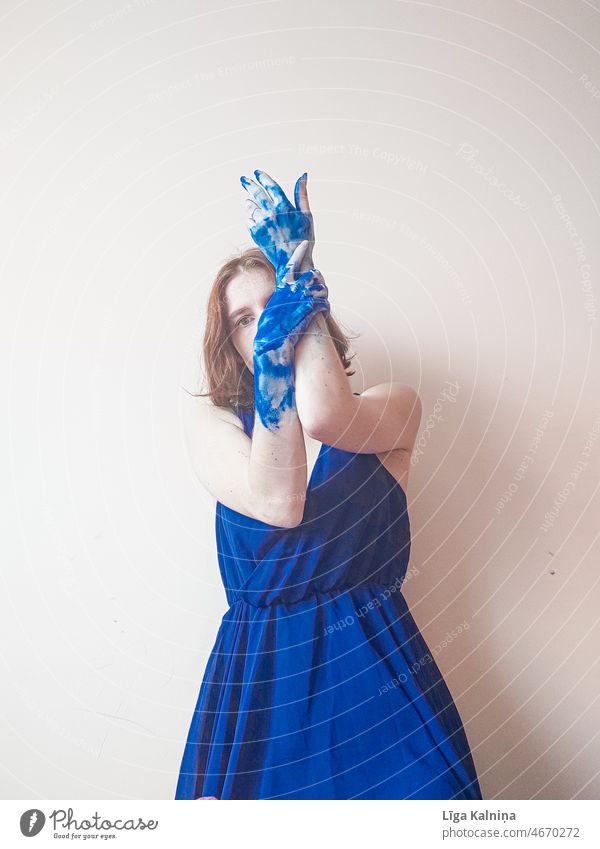 Porträt einer Frau in blauem Kleid und blauer Farbe an den Händen streichen Farbstoff Anstreicher Kreativität Pinselblume mehrfarbig Kunst malen Farbfoto