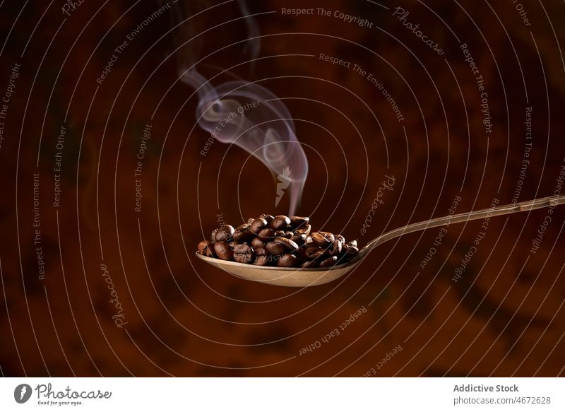Löffel voll mit erhitzten Kaffeebohnen auf braunem Hintergrund Bohne Braten Haufen Aroma Rauch Bestandteil Energie natürlich Koffein Korn Produkt lecker
