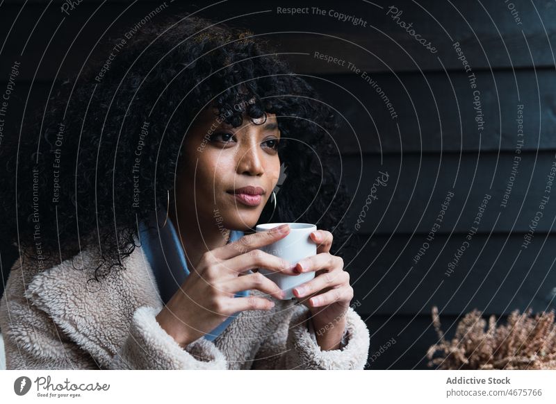 Schwarze Frau mit Tasse Kaffee trinken sich[Akk] entspannen ruhen Haus heimwärts Kälte Kaffeepause warm afroamerikanische Frau schwarze Frau Becher Heißgetränk