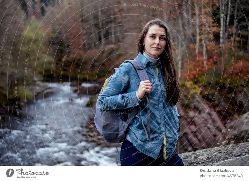 Reisende Frau brünett mit langen Haaren, Rucksack Wandern durch die Natur in den Bergen Herbst Jahreszeiten Person reisen Abenteuer im Freien Tourist Ausflug