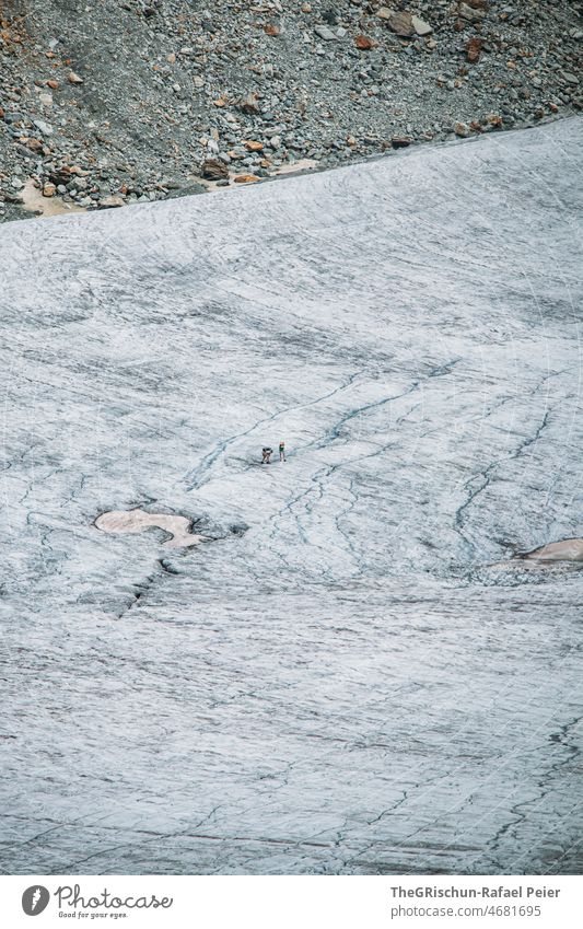 Personen laufen über den Gletscher Geröll risse Gletscherspalte Geröllfeld gestein Schnee Eis Gefahr schmelzen
