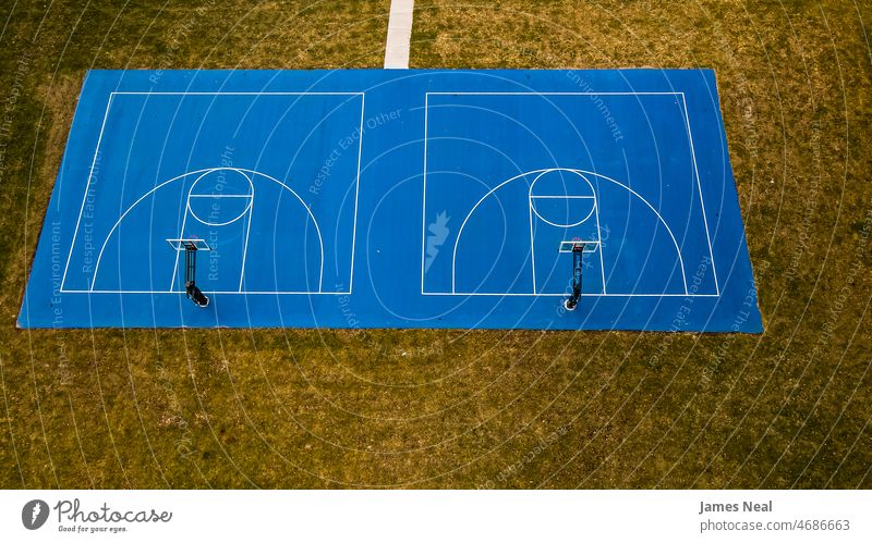 Blaues Basketballfeld mit Basketballkorb und grasbewachsenem Hintergrund Gras Herbst sonnig Farbe keine Menschen Natur Ball Land Sommer Dröhnen Netz außerhalb