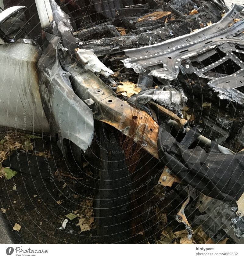 ausgebranntes Fahrzeug tagsüber auf Schrottplatz Totalschaden Metall Rost Vergänglichkeit Autowrack Zerstörung