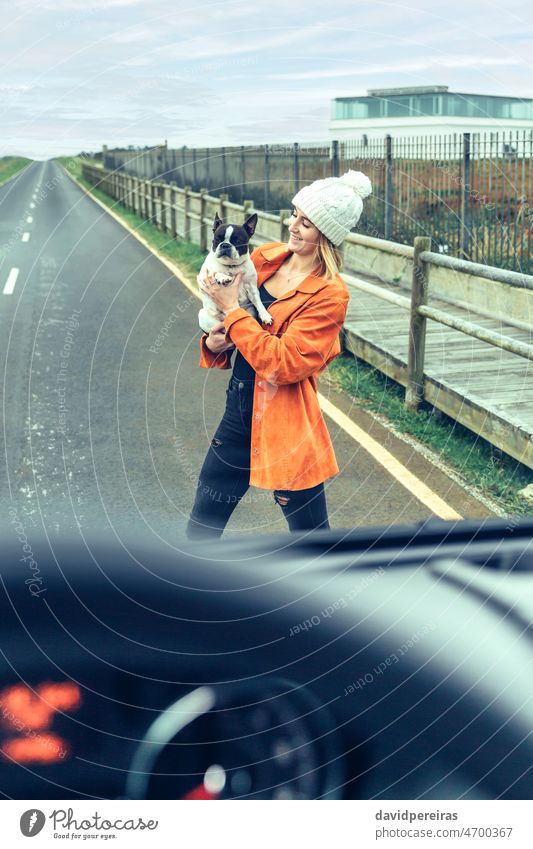 Blick aus dem Inneren des Wohnmobils auf eine Frau mit ihrem Hund jung Straße Blick von innen durch das Glas Kleintransporter Fahrzeug reisen Haustier