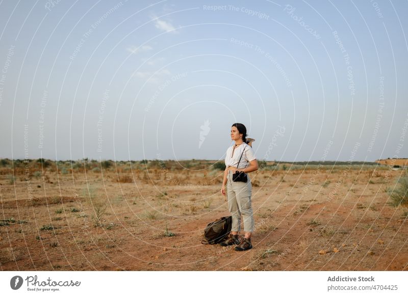 Frau mit Fernglas in einem Wüstenfeld Reisender Ausflug Abenteuer wüst trocken erkunden bewundern genießen unfruchtbar trocknen nachdenklich Harmonie besinnlich