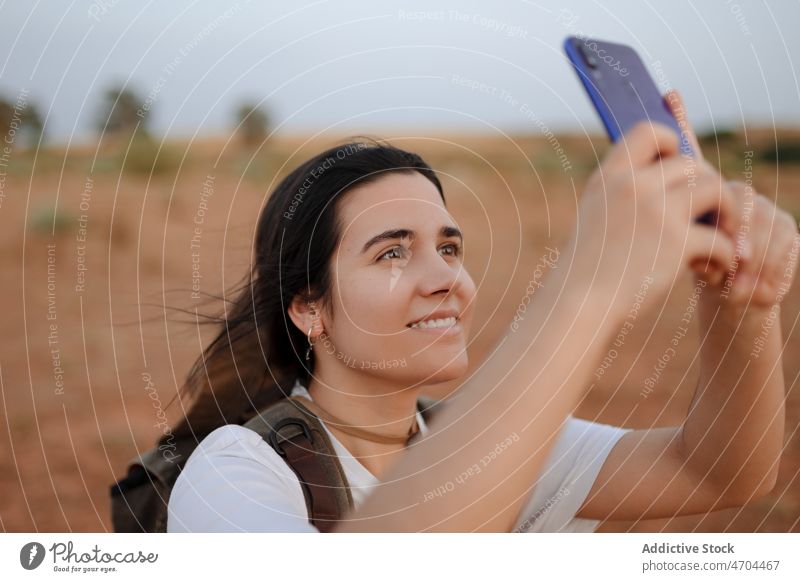 Frau nimmt Selfie in der Wüste Reisender Smartphone soziale Netzwerke einfangen wüst trocken Fundstück erkunden Lächeln Selbstportrait Gedächtnis Glück