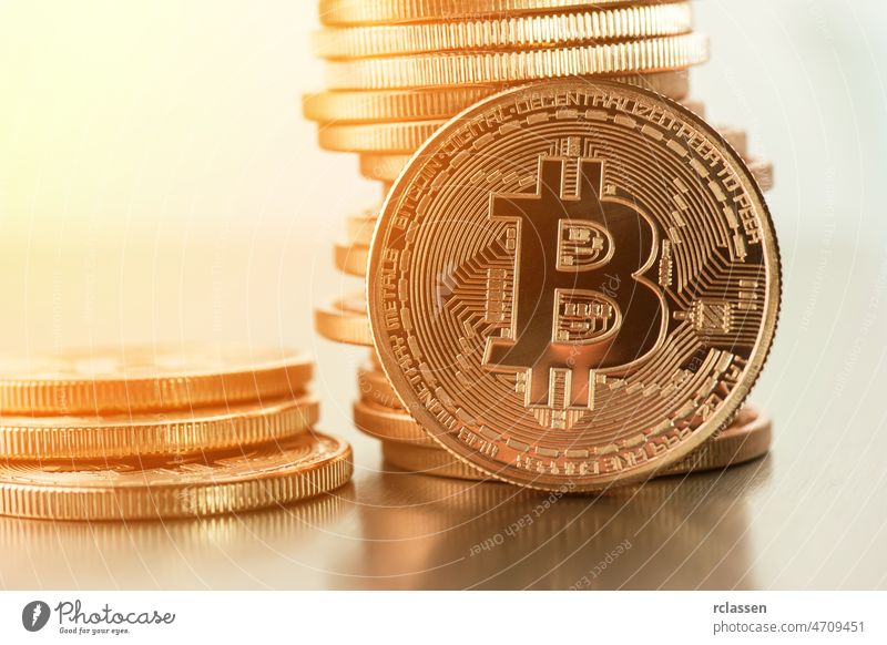 Goldene Bitcoins auf einem goldenen Hintergrund .Foto (neues virtuelles Geld) bitcoin Krypto Meissel Geldmünzen Business Symbol Konzept Zeichen Netz Metall