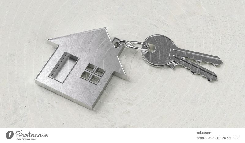 Schlüssel mit hausförmigem Schlüsselanhänger auf einem Betonboden als Hauskauf- und Wohnkonzept Taste Anwesen Immobilienmaklerin Markt wohnbedingt Kapital