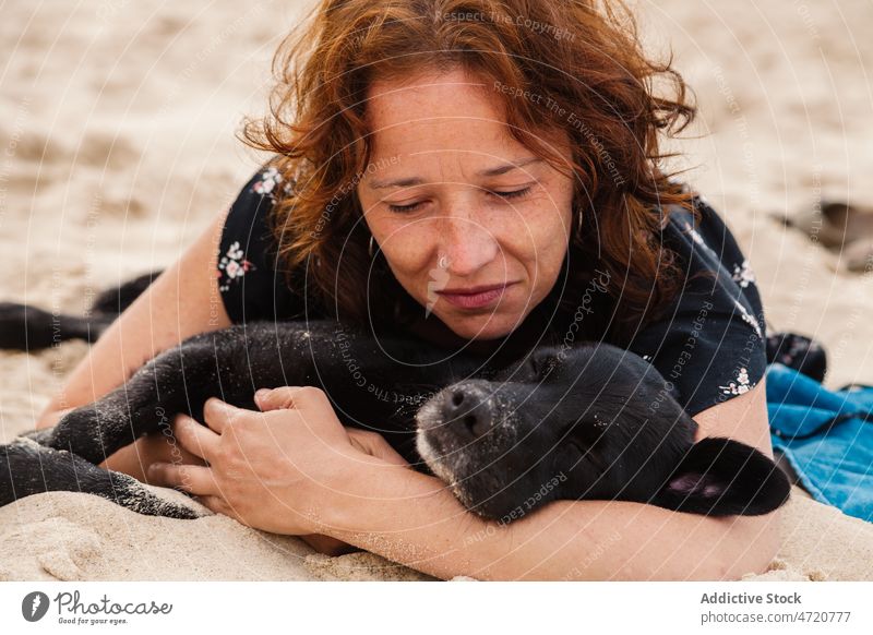Frau mit Hund am Strand liegend Haustier schlafen ruhen Ufer Erholung Kälte Tier Tourist Resort Meeresufer Sand Seeküste Meeresküste feminin Stil Natur Sommer