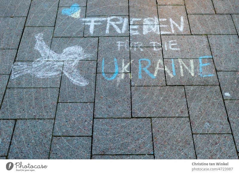 "Frieden für die Ukraine" , ein Herz und eine Friedenstaube. Mit Strassenmalkreide auf den Marktplatz gemalt. Friedenserklärung Friedensangebot Peace