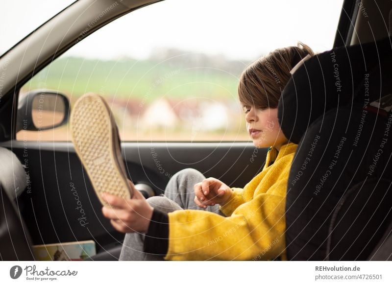 Kind sitzt im Auto Autofahren Verkehr Kindheit Sicherheit Mobilität mobil unterwegs Kindersitz sicher Porträt Ausflug gelb 7 Jahre Fahrt Verkehrsmittel PKW