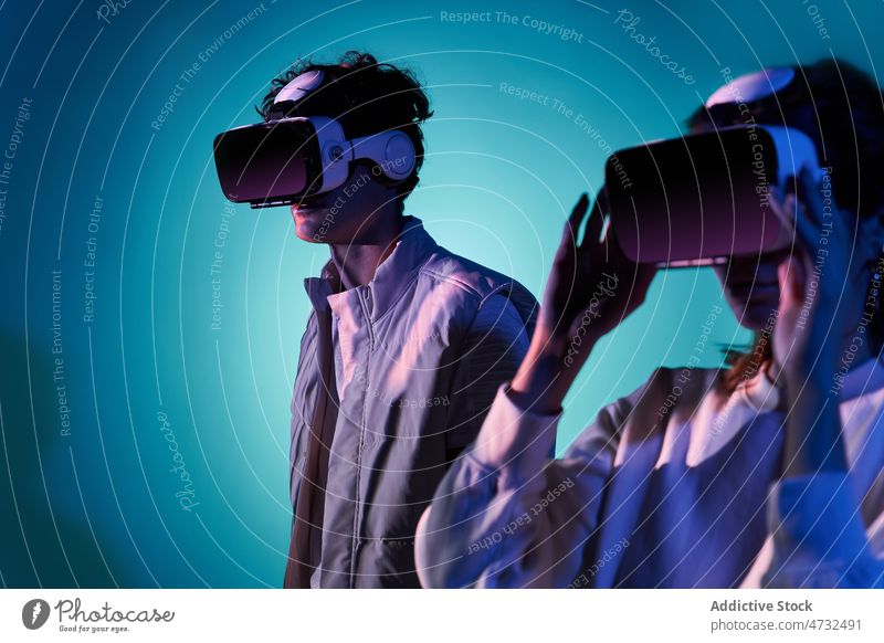 Paar erkundet virtuelle Realität im Studio VR Virtuelle Realität Headset Cyberspace Zukunft interaktiv Technik & Technologie erkunden futuristisch Schutzbrille