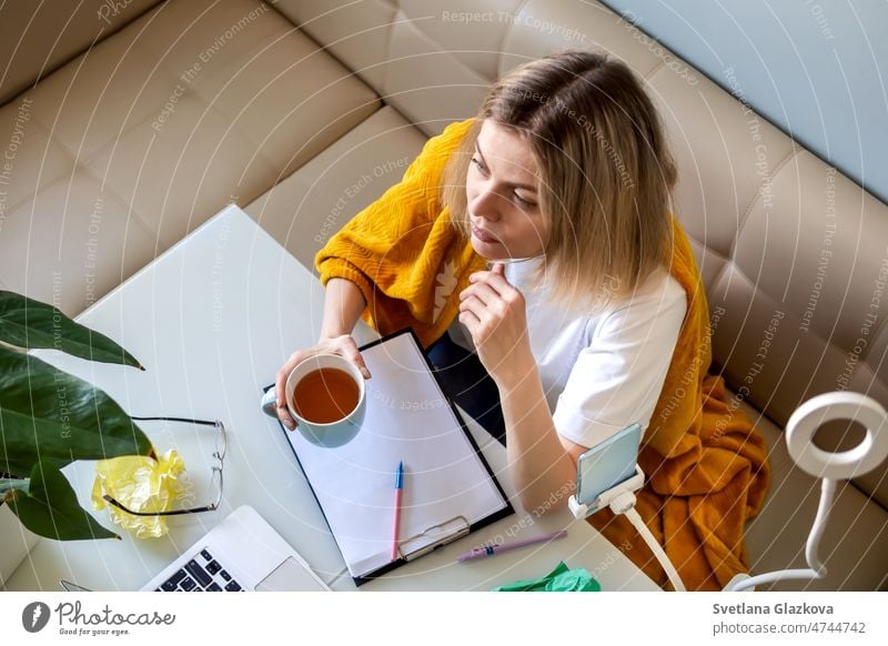 Arbeit in Arbeit. Blonde Frau in gelben karierten Arbeit im Büro zu Hause auf Küche Online-Chat mit Technologie sprechen Videokonferenz Smartphone