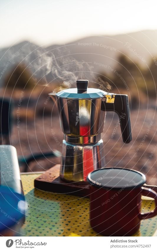 Aromatischer Kaffee in der Moka-Kanne auf dem Campingplatz Moka-Topf heiß Frühstück brauen Morgen erkunden Person Tasse Becher Kaffeemaschine Reise Getränk
