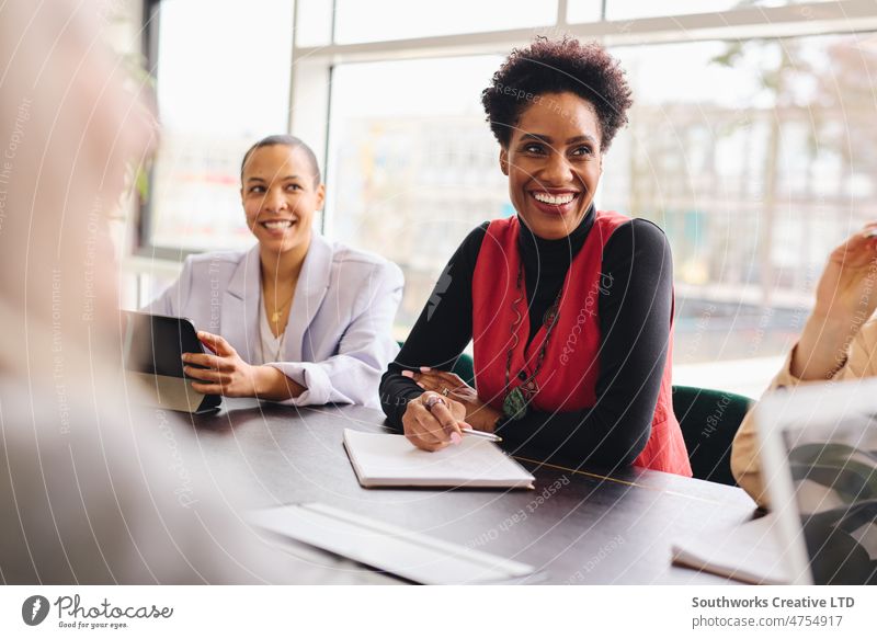 Porträt einer fröhlichen, reifen schwarzen Geschäftsfrau, die mit einem Notebook in einem Konferenzraum zuhört und lächelt Frauen Historie heiter Business