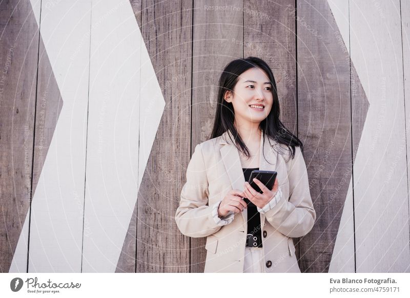 zuversichtlich, schöne chinesische Geschäftsfrau mit Handy in der Stadt. Technik Chinesisch asiatisch Frau Laptop Technik & Technologie Café Kaffee Kantine