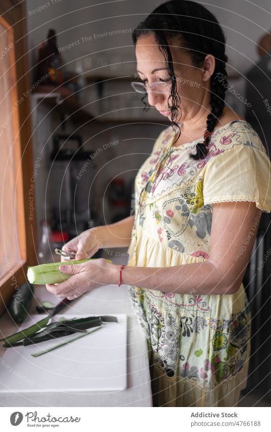 Mexikanische Frau schält Gurke in der Küche Salatgurke Gemüse sich[Akk] schälen Koch kulinarisch Lebensmittel gesunde Ernährung mexikanisch ethnisch