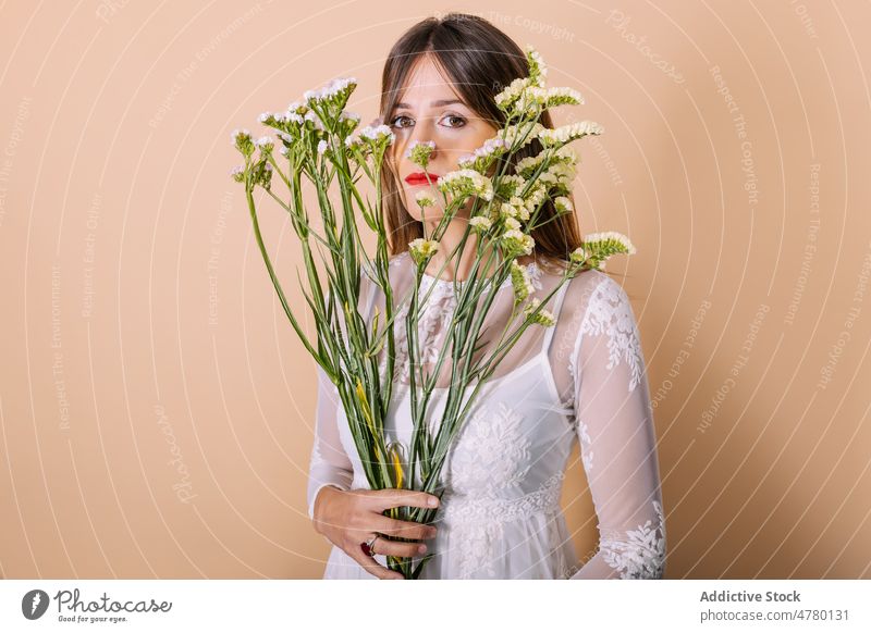 Braut im Kleid an Blumen riechend Frau weißes Kleid Hochzeit Stil Anlass Blumenstrauß geblümt Veranstaltung elegant Pflanze präsentieren duftig Aroma Feiertag