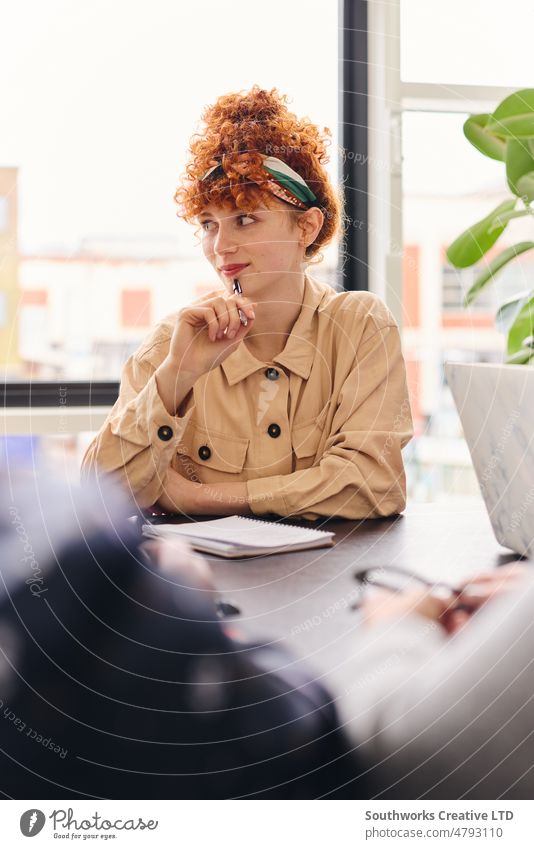 Porträt einer nachdenklichen jungen weißen Geschäftsfrau, die in einem Konferenzraum zuhört und einen Stift hält Frau Business besinnlich Kontemplation Sitzung