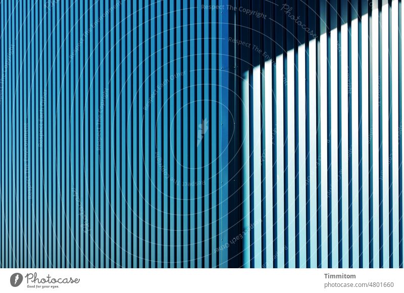 Blaue Fassade mit Licht und Schatten kühl blau Design Linien Schwarz Ecke hell Strukturen & Formen Gebäude Außenaufnahme Architektur Kontrast Menschenleer