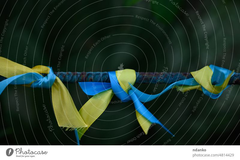blaues und gelbes Seidenband, das auf ein Metallrohr gebunden ist. Symbol der ukrainischen Flagge, Kampf für die Unabhängigkeit Ukraine Fahne Ukrainer Freiheit