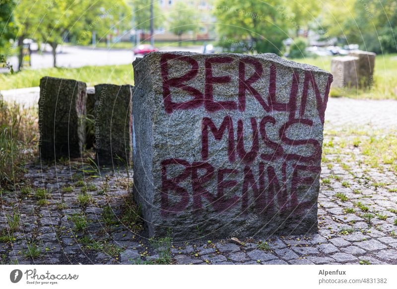 Berlin muss brenne Botschaft Schriftzeichen Stein Buchstaben Text Wort Aufforderung Menschenleer Mitteilung Farbfoto Außenaufnahme Park Volkspark Grünanlage