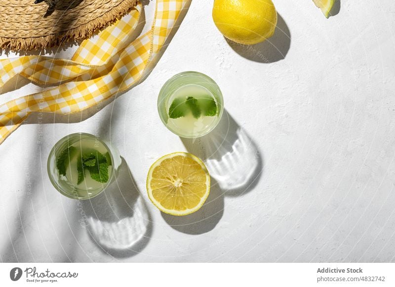 Flachlegung des Sommerkonzepts Konzept Zusammensetzung Zitrone frisch natürlich Gesundheit kreativ organisch Brille Getränke Hut gelb Farbe Schatten Sonnenlicht